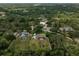 Aerial view of the property showcasing a spacious, fenced backyard, pool, and surrounding greenery at 13612 11Th E Ter, Bradenton, FL 34212