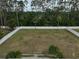 Aerial view of a large, fenced backyard with mature trees providing privacy and shade at 13612 11Th E Ter, Bradenton, FL 34212