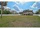 Expansive backyard featuring lush grass, a white fence, and a covered outdoor living space at 13612 11Th E Ter, Bradenton, FL 34212