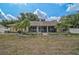 Home exterior features an enclosed patio, palm trees, and a well-maintained lawn at 13612 11Th E Ter, Bradenton, FL 34212
