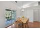 Light-filled dining area with wood floors and sliding glass doors to the patio at 13612 11Th E Ter, Bradenton, FL 34212
