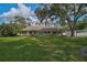 Inviting single-story home with a lush lawn and a spacious front yard shaded by mature trees at 13612 11Th E Ter, Bradenton, FL 34212