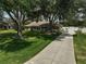 Pictureque home on an oversized lot features beautiful mature trees and a long concrete driveway at 13612 11Th E Ter, Bradenton, FL 34212