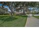 Quaint single-story house featuring mature landscaping, a long driveway, and a lush green lawn at 13612 11Th E Ter, Bradenton, FL 34212