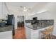Bright kitchen with white cabinets, granite countertops, modern appliances, and an island with seating at 13612 11Th E Ter, Bradenton, FL 34212