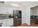Kitchen features stainless refrigerator, granite counters, and white cabinets at 13612 11Th E Ter, Bradenton, FL 34212