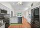 Open kitchen with stainless steel appliances and view to dining area at 13612 11Th E Ter, Bradenton, FL 34212