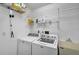 Functional laundry room with shelving, a utility sink, and modern appliances at 13612 11Th E Ter, Bradenton, FL 34212