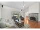 Cozy living room with brick fireplace and view of the backyard at 13612 11Th E Ter, Bradenton, FL 34212