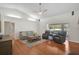 Bright living room with ceiling fan, hardwood floors, and comfortable seating at 13612 11Th E Ter, Bradenton, FL 34212
