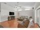 Open living room featuring wood floors, vaulted ceilings, and comfortable furniture at 13612 11Th E Ter, Bradenton, FL 34212