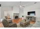 Spacious living room with fireplace, ceiling fan, and plenty of seating at 13612 11Th E Ter, Bradenton, FL 34212