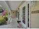 Inviting front porch featuring stylish white railings, a welcoming mat, and classic lanterns at 13612 11Th E Ter, Bradenton, FL 34212