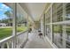 Welcoming front porch featuring a tiled floor, white pillars, and a view of the lush front yard at 13612 11Th E Ter, Bradenton, FL 34212
