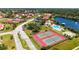 Aerial view showcases the community's tennis courts, shuffleboard, pool, clubhouse, and pond at 1431 57Th W St # 1431, Bradenton, FL 34209
