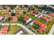 An aerial view of community properties featuring red roofs, lush landscaping, and pond at 1431 57Th W St # 1431, Bradenton, FL 34209