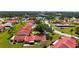 Aerial showcases well-maintained lawns, mature trees, and homes with red tile roofs in a verdant neighborhood at 1431 57Th W St # 1431, Bradenton, FL 34209