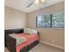 Cozy bedroom features a daybed, ceiling fan, and large window with natural light at 1431 57Th W St # 1431, Bradenton, FL 34209