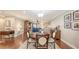 Open concept dining area with wood floors, neutral walls, and stylish decor at 1431 57Th W St # 1431, Bradenton, FL 34209