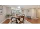 Dining area adjacent to kitchen with wood floors, neutral paint, and wainscotting at 1431 57Th W St # 1431, Bradenton, FL 34209