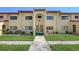 The condo building has yellow walls, a red tile roof, and a well-manicured lawn at 1431 57Th W St # 1431, Bradenton, FL 34209