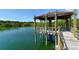 A gazebo on a lake with wooden supports and a table inside at 1431 57Th W St # 1431, Bradenton, FL 34209