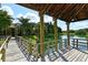 Interior view of a gazebo featuring wooden railings overlooking a serene lake at 1431 57Th W St # 1431, Bradenton, FL 34209