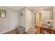 Hallway view with wood floors, white doors, and access to bathroom at 1431 57Th W St # 1431, Bradenton, FL 34209