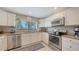 Bright kitchen features stainless steel appliances, granite countertops, and white cabinetry at 1431 57Th W St # 1431, Bradenton, FL 34209