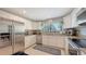 Bright, white kitchen with stainless steel appliances, granite countertops, and ample cabinet space at 1431 57Th W St # 1431, Bradenton, FL 34209