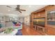 Comfortable living room featuring hardwood floors, plush seating, and built in shelving at 1431 57Th W St # 1431, Bradenton, FL 34209