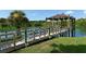 A wooden pier leading to covered gazebo sitting on a small lake at 1431 57Th W St # 1431, Bradenton, FL 34209