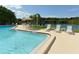 Sparkling community pool with lake view and lounge seating at 1431 57Th W St # 1431, Bradenton, FL 34209