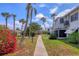 Well-manicured community grounds featuring walkways, palm trees, landscaping and building exteriors at 1535 Pleasant Rd # H5, Bradenton, FL 34207