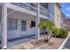 Condo building exterior showcasing unit 135, front entrance, and tropical landscaping at 1535 Pleasant Rd # H5, Bradenton, FL 34207