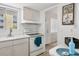 Bright kitchen with white cabinetry, white appliances, and a view to the exterior at 1535 Pleasant Rd # H5, Bradenton, FL 34207