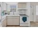 This kitchen features white cabinets, tiled countertops and backsplash and modern appliances at 1535 Pleasant Rd # H5, Bradenton, FL 34207