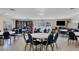 Inviting meeting room offering tables and chairs, a TV, and a well-stocked bookshelf at 1535 Pleasant Rd # H5, Bradenton, FL 34207