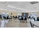 Bright meeting room featuring multiple tables, comfortable chairs, and natural light through the windows at 1535 Pleasant Rd # H5, Bradenton, FL 34207