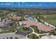 Stunning aerial view featuring a clubhouse, a large community pool, and well-manicured landscaping at 17704 Gawthrop Dr # 102, Bradenton, FL 34211