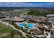 Breathtaking aerial view of a resort-style pool, lush greenery, and a well-appointed clubhouse at 17704 Gawthrop Dr # 102, Bradenton, FL 34211
