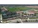 Expansive aerial view showcasing tennis courts, a clubhouse, and a refreshing community pool at 17704 Gawthrop Dr # 102, Bradenton, FL 34211