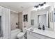 Bathroom showcasing quartz countertop, matte black faucet, tub-shower combo, and modern decor at 17704 Gawthrop Dr # 102, Bradenton, FL 34211