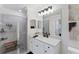 Bathroom features a glass-enclosed shower with gray tiling, and white vanity with a white countertop at 17704 Gawthrop Dr # 102, Bradenton, FL 34211