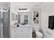 Well-lit bathroom featuring a vanity with a quartz countertop, tile shower, and decorative wall art at 17704 Gawthrop Dr # 102, Bradenton, FL 34211