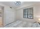 Bright bedroom with decorative chandelier, features a large window for ample natural light at 17704 Gawthrop Dr # 102, Bradenton, FL 34211