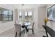 Bright breakfast nook features a round glass table with seating for four and bright light from the window at 17704 Gawthrop Dr # 102, Bradenton, FL 34211