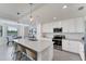 Bright kitchen with white cabinets, stainless appliances, and island seating, perfect for entertaining at 17704 Gawthrop Dr # 102, Bradenton, FL 34211