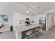 Modern kitchen featuring white cabinets, stainless steel appliances, and a large island with seating at 17704 Gawthrop Dr # 102, Bradenton, FL 34211