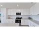 Modern kitchen with white cabinets, stainless steel appliances, and white subway tile backsplash at 17704 Gawthrop Dr # 102, Bradenton, FL 34211